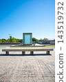 A modern plaza and water feature landscape spread out under a blue sky. 143519732