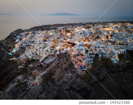 Aerial Drone View of Oia, Santorini. A breathtaking aerial view of the whitewashed village of Oia, Santorini, showcasing luxury resorts with infinity pools overlooking the Aegean Sea. A stunning blend Aerial Drone View of Oia, Santorini. A breathtaking aerial view of the whitewashed village of Oia, Santorini, showcasing luxury resorts with infinity pools overlooking the Aegean Sea. A stunning blend 143521380