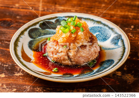 Juicy chicken meatballs served with refreshing grated daikon radish and ponzu sauce. Juicy chicken meatballs served with refreshing grated daikon radish and ponzu sauce. 143522366