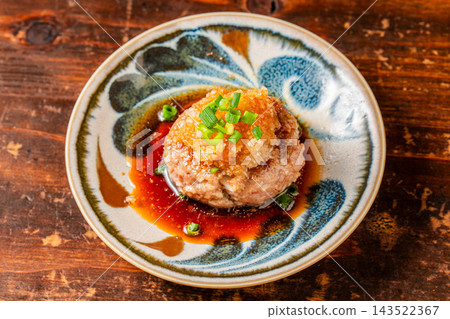 Juicy chicken meatballs served with refreshing grated daikon radish and ponzu sauce. Juicy chicken meatballs served with refreshing grated daikon radish and ponzu sauce. 143522367