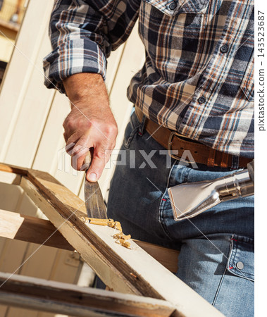 Carpenter at work, restoring an old wooden window. Carpentry. Carpenter at work, restoring an old wooden window. Carpentry. 143523687