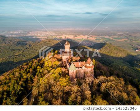 Secluded castle overlooking vineyard dotted valley with rolling. Castle Haut-Koenigsbourg, Alsace, France - April 10, 2026 - Secluded castle overlooking vineyard dotted valley with rolling fields and Secluded castle overlooking vineyard dotted valley with rolling. Castle Haut-Koenigsbourg, Alsace, France - April 10, 2026 - Secluded castle overlooking vineyard dotted valley with rolling fields and 143525046