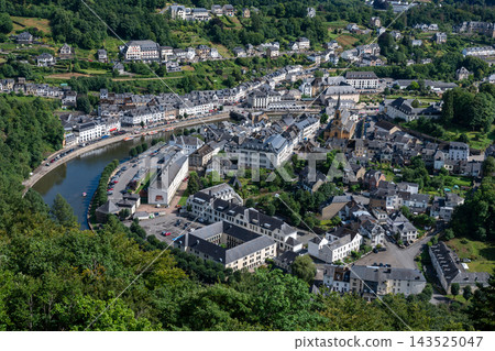 The view of Bouillon Panorama in sunny summer day. Sunny summer view over Bouillon with its green hills, historic charm, and bright blue sky creating a peaceful, picturesque landscape. The view of Bouillon Panorama in sunny summer day. Sunny summer view over Bouillon with its green hills, historic charm, and bright blue sky creating a peaceful, picturesque landscape. 143525047