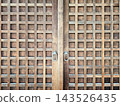 Traditional Japanese Wooden Lattice Doors with Metal Handles Texture. 143526435