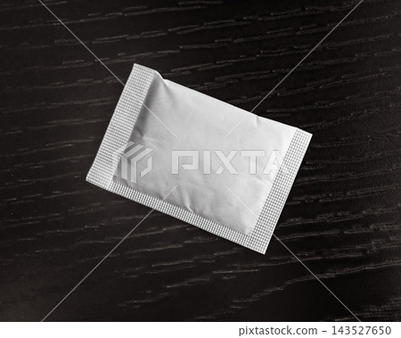 Blank white sachet mockup packet on wooden surface Blank white sachet mockup packet on wooden surface 143527650