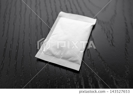 selective focus of blank white sachet mockup packet on wooden surface selective focus of blank white sachet mockup packet on wooden surface 143527653
