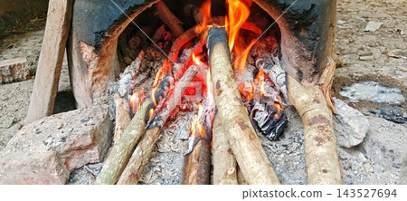 Traditional wood fire burning in clay stove outdoor Traditional wood fire burning in clay stove outdoor 143527694