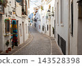 Exploring Altea's charming old town with its picturesque winding cobblestone streets, an ideal setting for memorable Spanish family holidays and vacations 143528398
