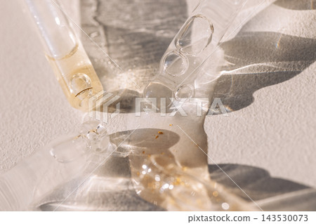 Close-up of glass pipettes with moisturizing serum with colloidal gold. Close-up of glass pipettes with moisturizing serum with colloidal gold. 143530073