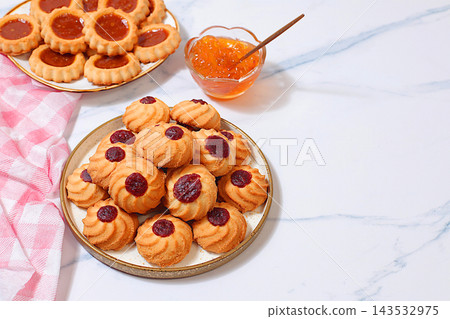 Homemade shortbread cookies with jam and preserves on a marble background, concept for modern baking and grain based treats. An idea for a healthy breakfast a cafe or restaurant menu or template 143532975