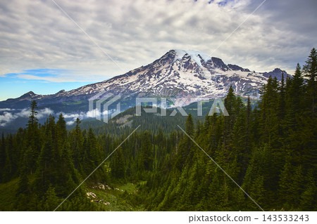 Mount Rainier Snow Capped Peak with Evergreen Forest and Misty Valley in Washington Mount Rainier Snow Capped Peak with Evergreen Forest and Misty Valley in Washington 143533243