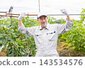 A man in work clothes working in a field 143534576