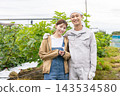 Farmer men and women who harvest vegetables 143534580