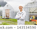 A man wearing work clothes 143534590