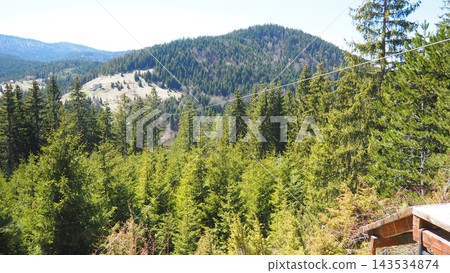 Nova Varos, Zlatar, Serbia. Cable inclined rope is ridden from height gravity influence is zipline or troll. Zipline, zip-line or funiculaire downhill in mountains, parks and canyons. Nova Varos, Zlatar, Serbia. Cable inclined rope is ridden from height gravity influence is zipline or troll. Zipline, zip-line or funiculaire downhill in mountains, parks and canyons. 143534874
