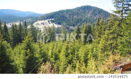 Nova Varos, Zlatar, Serbia. Cable inclined rope is ridden from height gravity influence is zipline or troll. Zipline, zip-line or funiculaire downhill in mountains, parks and canyons. Nova Varos, Zlatar, Serbia. Cable inclined rope is ridden from height gravity influence is zipline or troll. Zipline, zip-line or funiculaire downhill in mountains, parks and canyons. 143534875