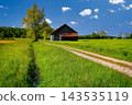 Rustic Barn in a Lush Green European Countryside Landscape 143535119