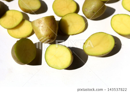 Raw potatoes on a white background. Raw potatoes on a white background. 143537822