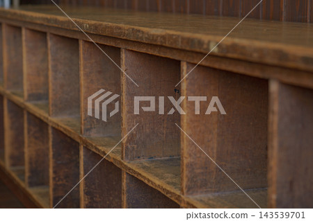 An old wooden storage shelf with rows of dividers An old wooden storage shelf with rows of dividers 143539701