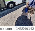 The feet of elderly people waiting in line while boarding the bus 143540142