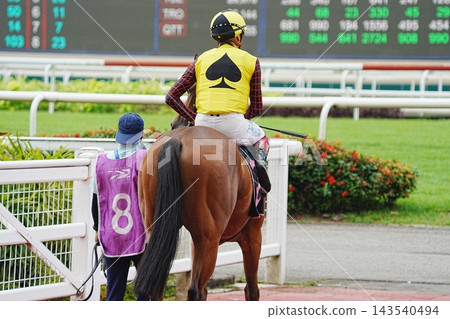 Horse Racing Jockey at the Track Waiting for Next Race Horse Racing Jockey at the Track Waiting for Next Race 143540494