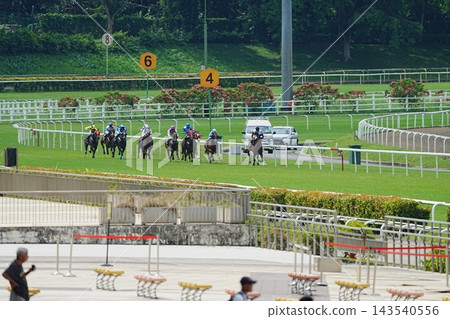 Horse Race in Progress at the Racetrack Singapore 143540556