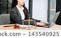 Justice and law concept.Male judge in a courtroom on white table and Counselor or Female lawyer working Justice and law concept.Male judge in a courtroom on white table and Counselor or Female lawyer working 143540925