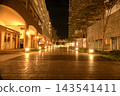 A deserted nighttime promenade with warm lighting. 143541411