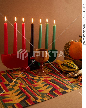 Kwanzaa kinara with mishumaa saba and traditional symbols Kwanzaa kinara with mishumaa saba and traditional symbols 143541444
