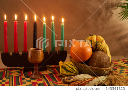 Kinara with candles, unity cup, and harvest produce celebrating kwanzaa Kinara with candles, unity cup, and harvest produce celebrating kwanzaa 143541823