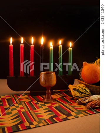 Kwanzaa celebration with kinara, mishumaa saba, and unity cup 143541840
