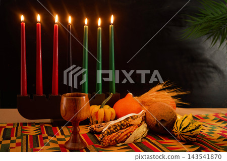 Kwanzaa kinara with seven lit candles and fruits Kwanzaa kinara with seven lit candles and fruits 143541870