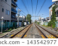 Railway tracks and overhead wires stretching straight through a Japanese residential area. 143542977