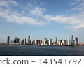 Viewing Manhattan's skyscrapers from a boat in the early morning. 143543792