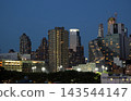 Views of Manhattan's skyscrapers and harbor from a ship at night. 143544147