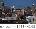 The Manhattan skyline at night as seen from a ship. 143544148