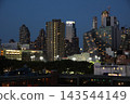 Nighttime view of Manhattan's skyscrapers from a ship 143544149