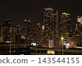 Nighttime view of Manhattan's skyscrapers from a ship 143544155