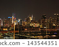 Views of Manhattan's skyscrapers and harbor from a ship at night. 143544351