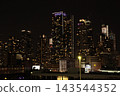 Nighttime view of Manhattan's skyscrapers from a ship 143544352