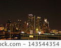 Nighttime view of Manhattan's skyscrapers from a ship 143544354
