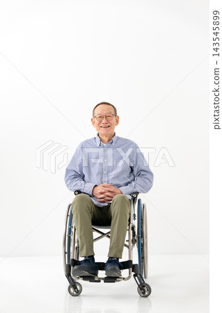 A senior man in a wheelchair, full body shot. A senior man in a wheelchair, full body shot. 143545899
