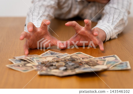 A man reaching for money A man reaching for money 143546102