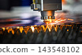 Industrial CNC laser cutting machine with flying sparks in metal fabrication. 143548102