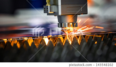 Industrial CNC laser cutting machine with flying sparks in metal fabrication. Industrial CNC laser cutting machine with flying sparks in metal fabrication. 143548102