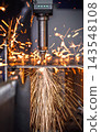Industrial CNC laser cutting machine with flying sparks in metal fabrication. 143548108
