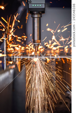 Industrial CNC laser cutting machine with flying sparks in metal fabrication. Industrial CNC laser cutting machine with flying sparks in metal fabrication. 143548108