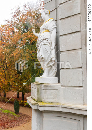 Allegorical female statue of the Four Parts of the Day cycle on the facade of the historic baroque Rococo Pavillon Losthaus (or Lusthaus) in a public park of Echternach, Luxembourg 143550190