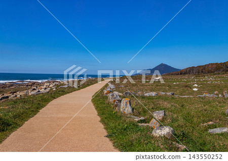 Scenic view of the Ecovia Litoral Norte paved path along the Atlantic Ocean with Mount Santa Tecla on the horizon near Vila Praia de Ancora, Portugal Scenic view of the Ecovia Litoral Norte paved path along the Atlantic Ocean with Mount Santa Tecla on the horizon near Vila Praia de Ancora, Portugal 143550252