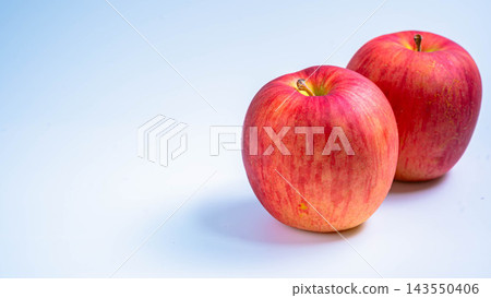Image of two Sun Tsugaru apples against a white background. 143550406